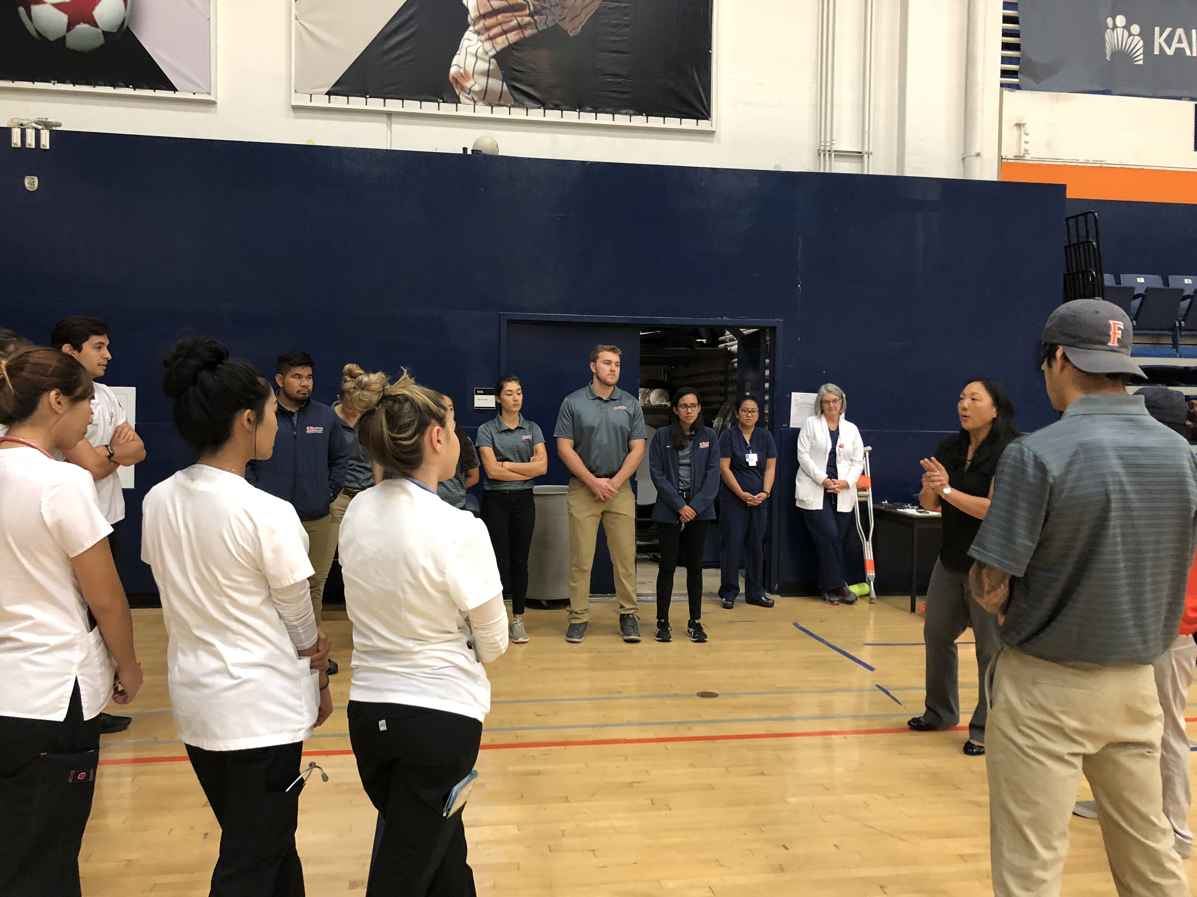 students standing on basketball court